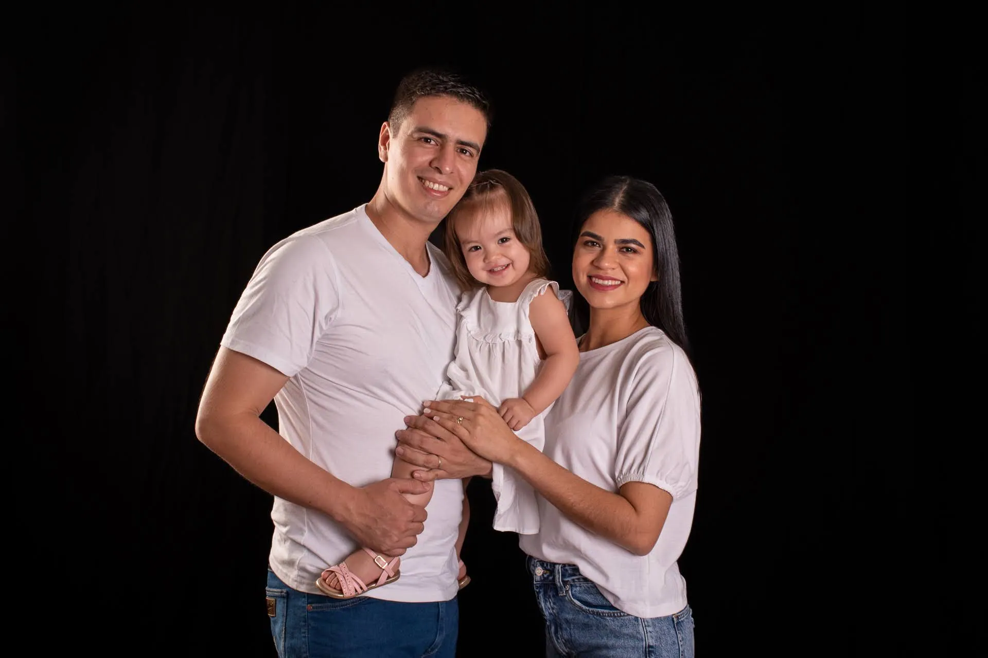 Familia posando en estudio con su hija